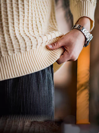 Close-up of Waffle Knit Crewneck Sweater off-white showing ribbed cuff, hem detail, and soft textured knit fabric