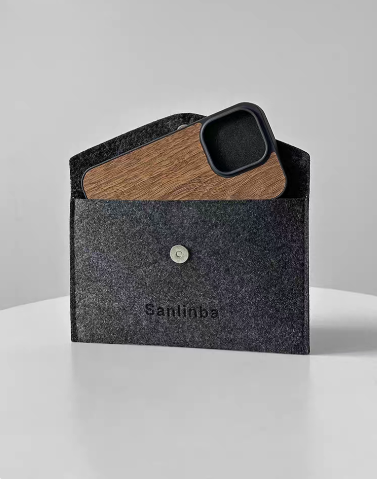 Walnut wood MagSafe phone case in natural finish placed inside felt sleeve pouch showing premium storage and protection