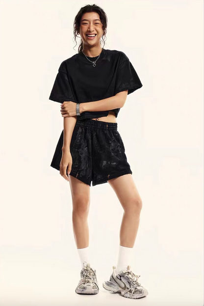 Black washed cropped tee with relaxed lounge shorts full outfit front view on model