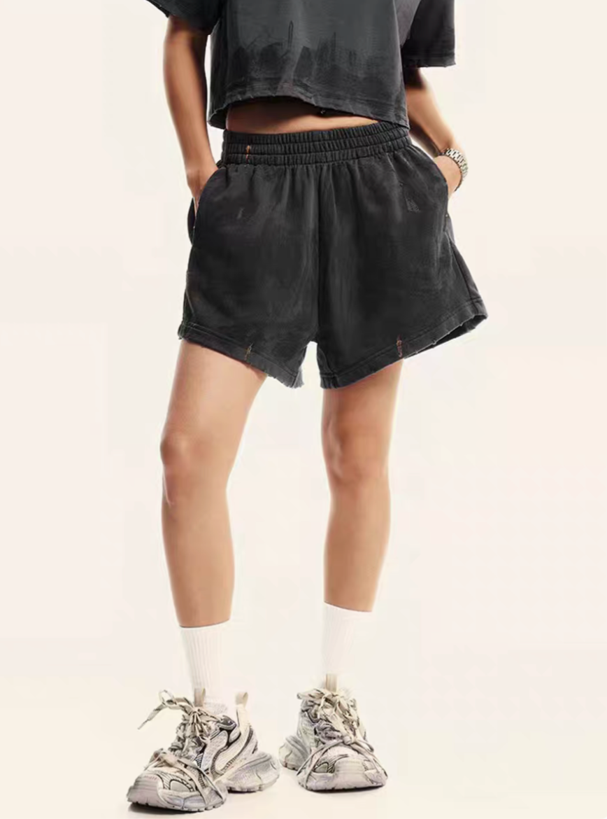 Charcoal gray lounge shorts front close-up on model with elastic waistband and pockets