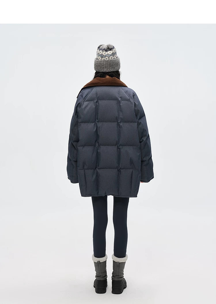 Back view of slate blue denim down coat showing channel quilting and corduroy collar