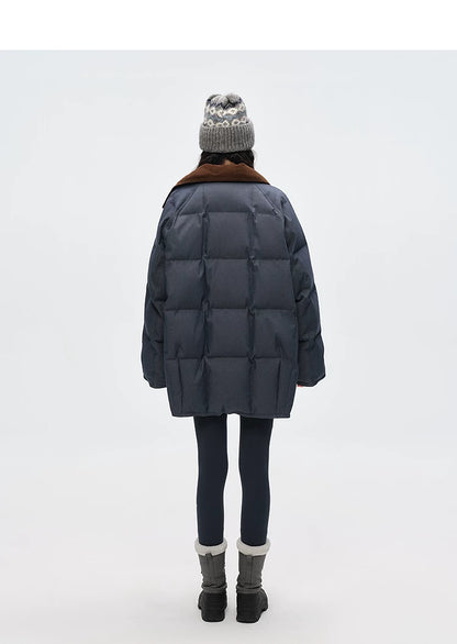 Back view of slate blue denim down coat showing channel quilting and corduroy collar