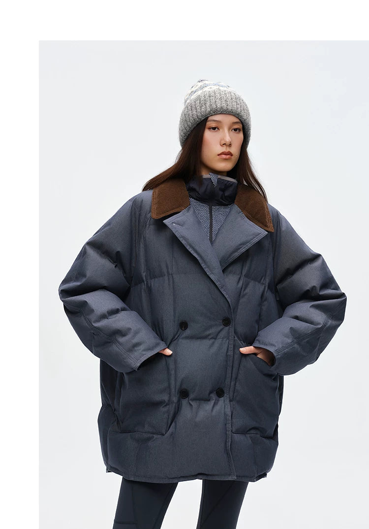 Slate blue denim down peacoat buttoned closed with hands in patch pockets