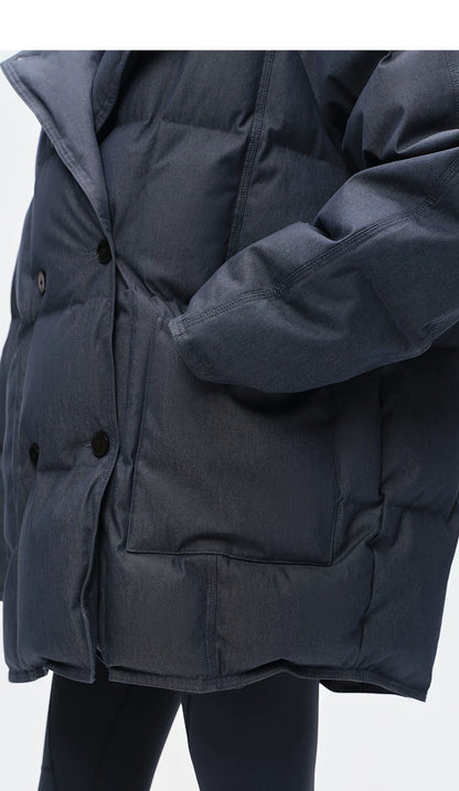 Close-up of double-breasted buttons and deep patch pocket on washed denim down coat