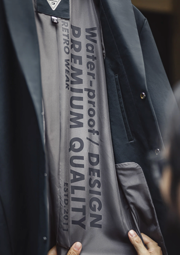 Premium lining with retro text inside waterproof Mac coat