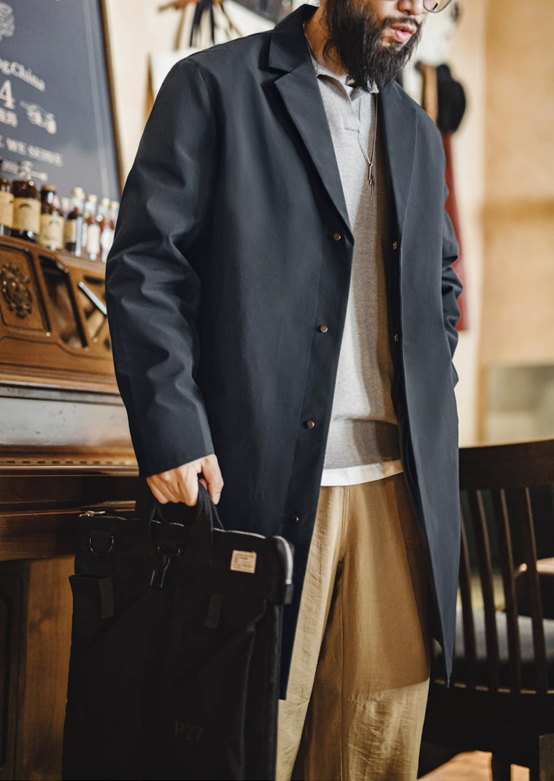 Model wearing waterproof Mac coat styled with casual outfit