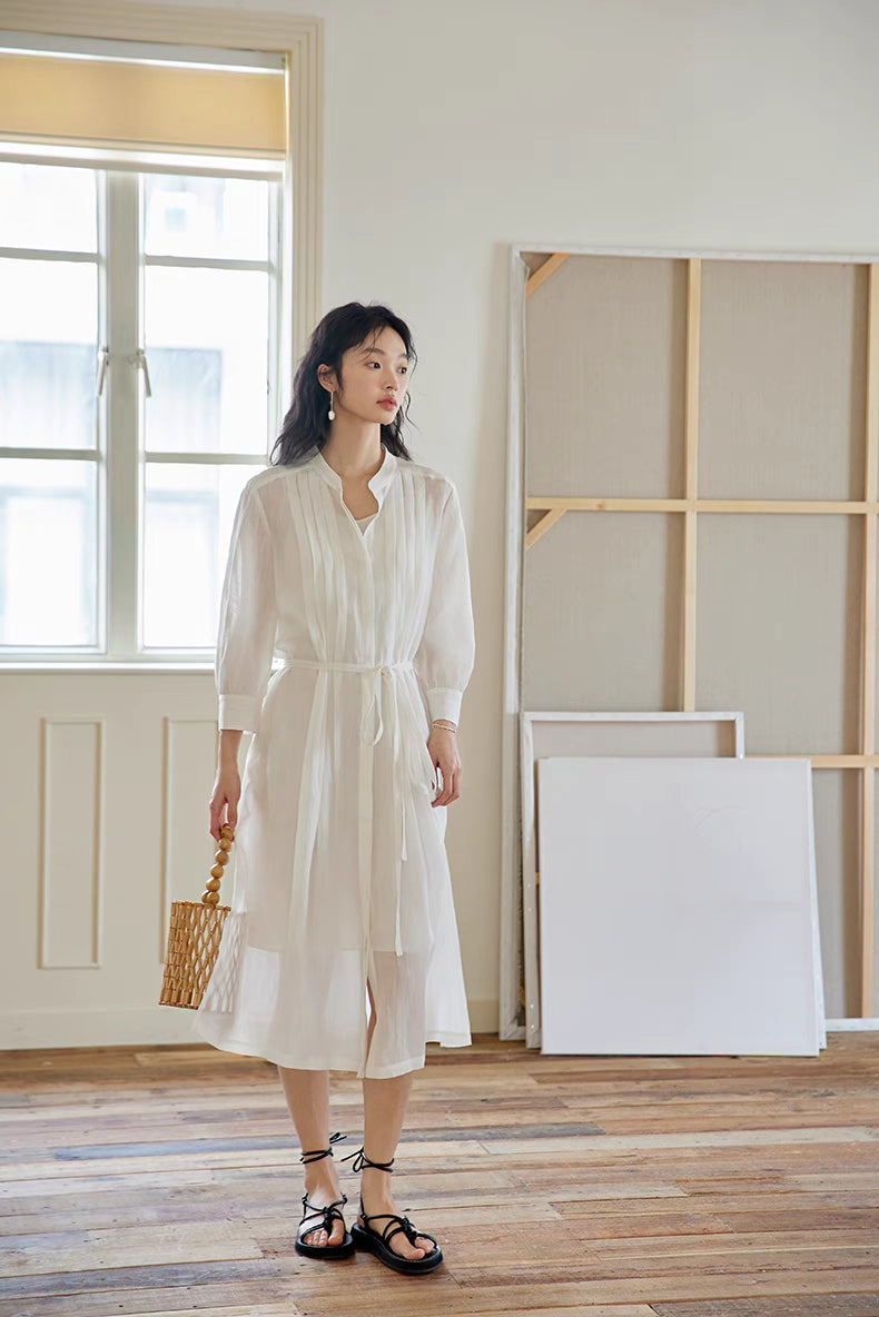 Model wearing White pleated midi dress in full-body front view, showcasing airy A-line silhouette, soft flow, and elegant lightweight design