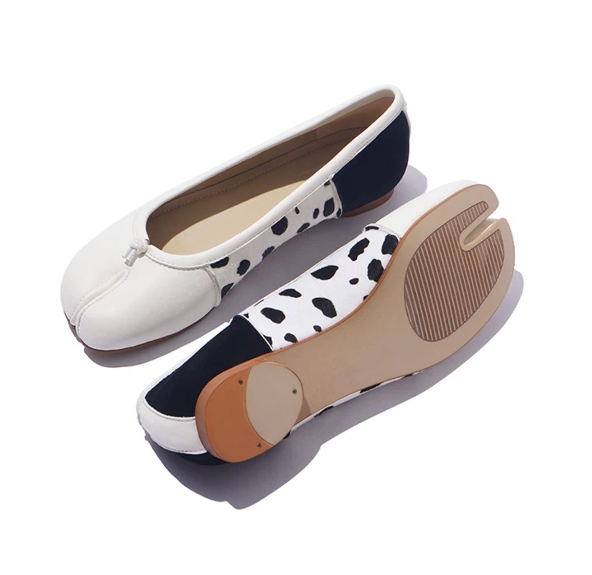 White tabi ballet flats showing the split-toe outsole with ribbed tread and heel toplift