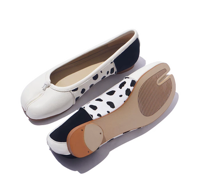White tabi ballet flats showing the split-toe outsole with ribbed tread and heel toplift