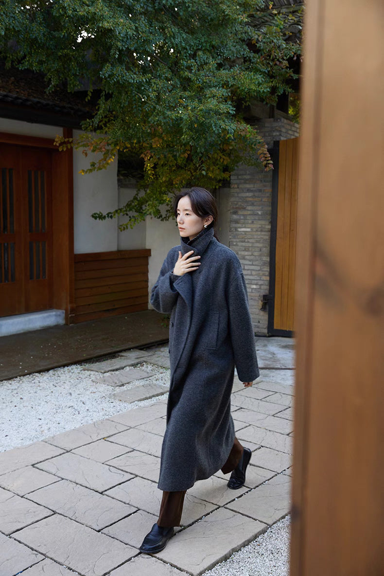 Woman walking outdoors in dark gray long Willow Lane Wool Coat, highlighting fluid movement, structured silhouette, and timeless winter style