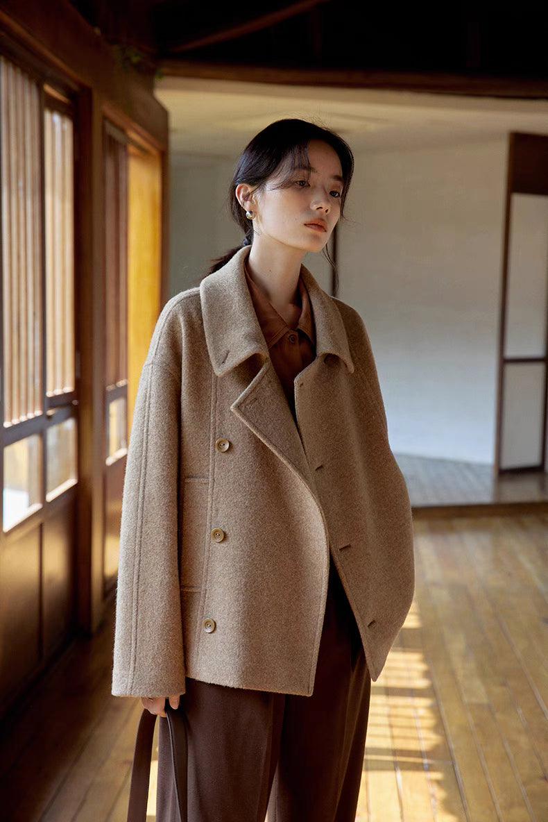 Woman wearing Willow Lane Wool Coat in khaki short style front view, featuring button closure, cropped length, and structured wool finish