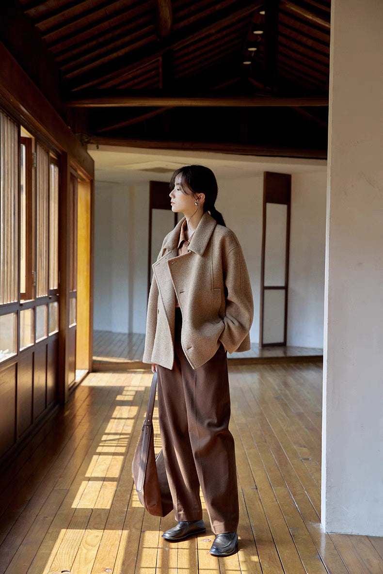 Full outfit of woman wearing khaki short Willow Lane Wool Coat paired with wide-leg pants, showcasing versatile styling and clean silhouette