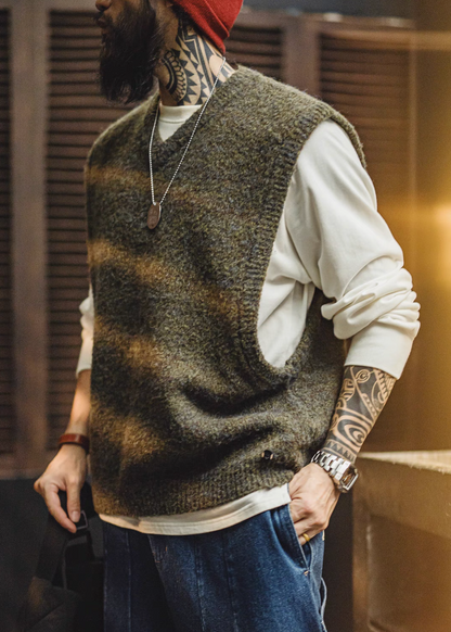 Side angle view of model wearing Woodland Retro V-Neck Vest in Moss Green styled with white shirt and jeans casual outfit