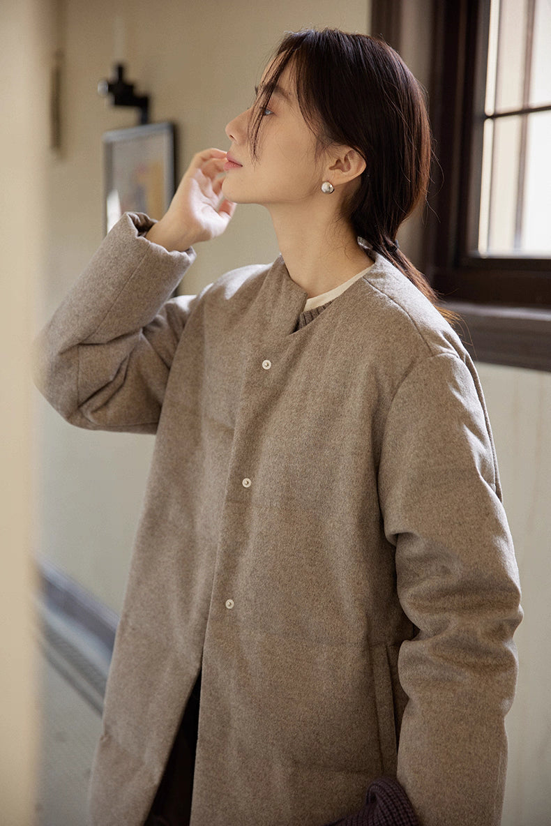close-up of round-neck wool-blend long down coat with snap buttons