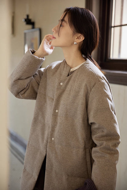 close-up of round-neck wool-blend long down coat with snap buttons