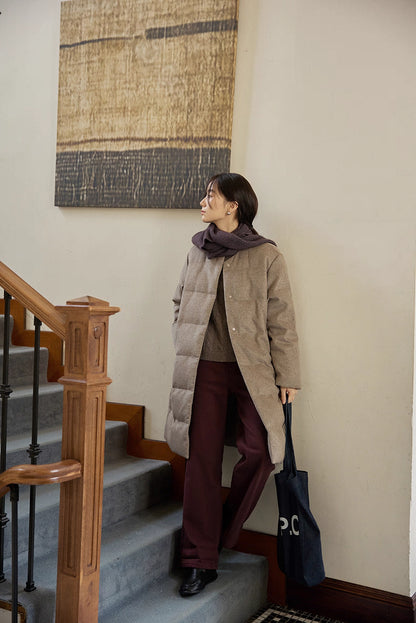 full-body view of wool-blend long down coat styled with scarf in hallway