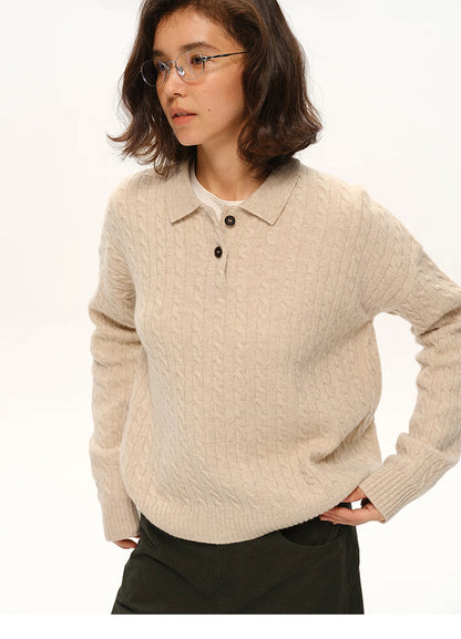 Model wearing beige cable-knit wool polo sweater, front view with hands in pockets
