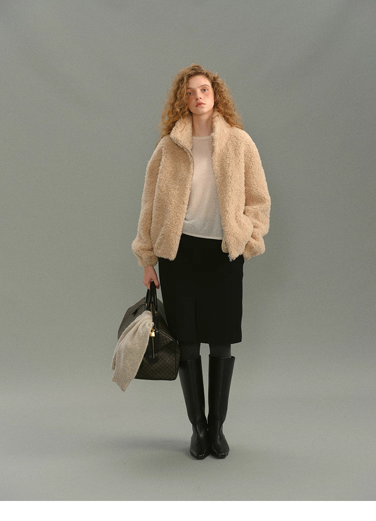 Model wearing cream beige 100% wool high-neck jacket with skirt and knee boots, full front view