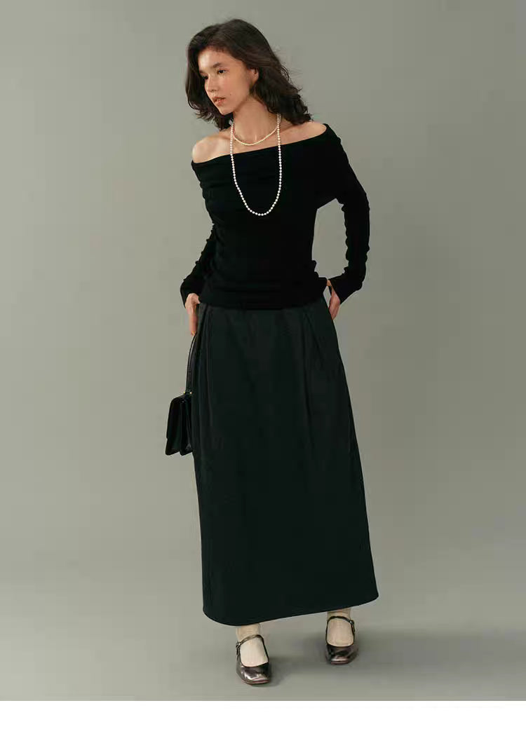 Full-body shot of black off-shoulder wool top paired with a long black skirt and metallic shoes