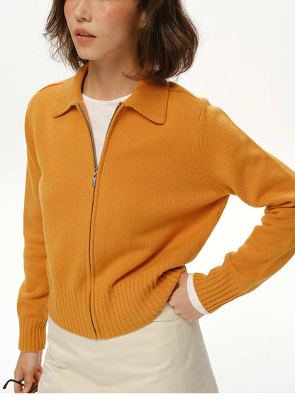 Close-up of mustard wool zip-up collared sweater showing dense knit, zipper and ribbed hem