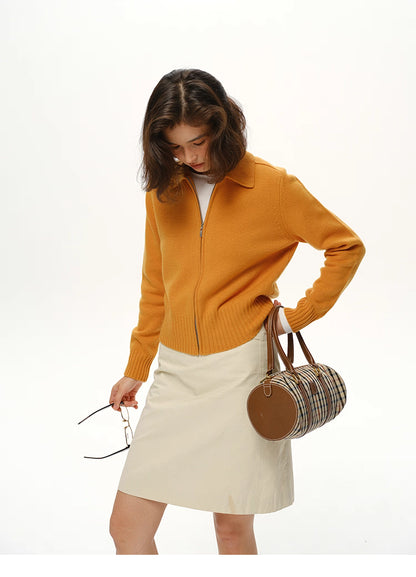 Mustard wool zip collar jacket styled with cream skirt and plaid barrel bag, lifestyle look