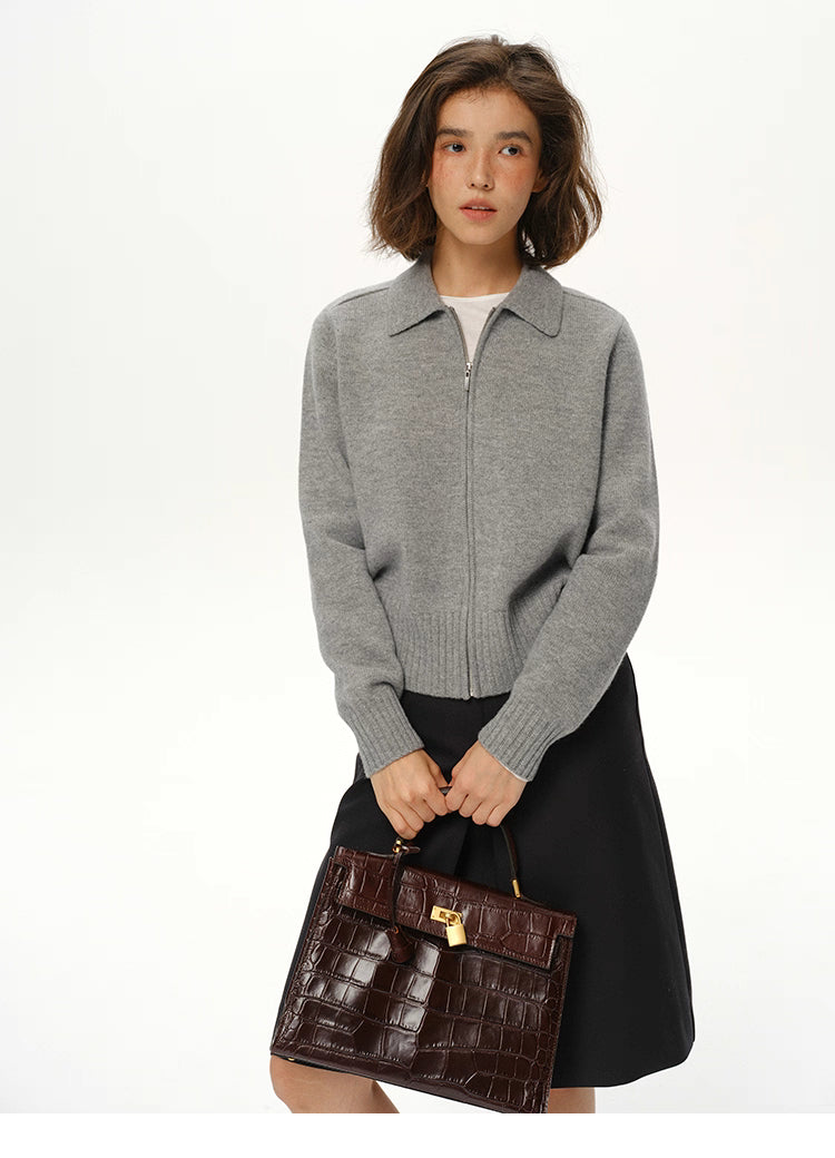 Medium grey wool zip collar knit jacket on model with black skirt and brown structured handbag