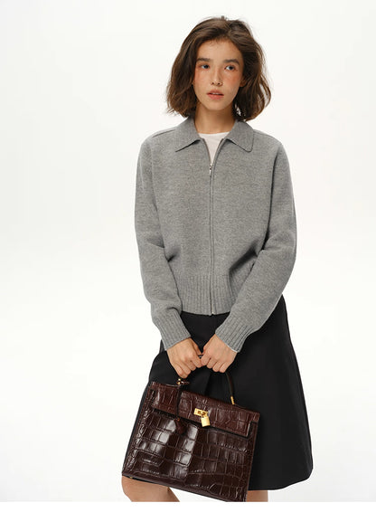 Medium grey wool zip collar knit jacket on model with black skirt and brown structured handbag