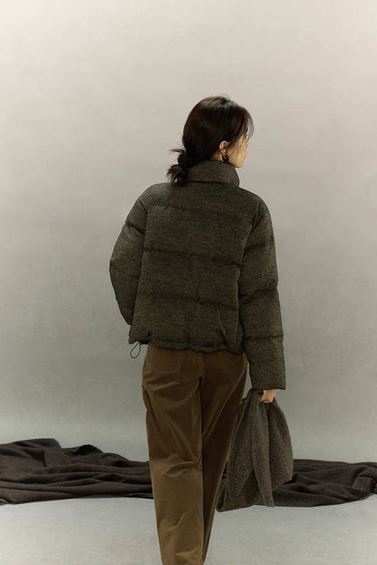 Back view of wool-blend down jacket showing hip-length cut and hem drawcord.