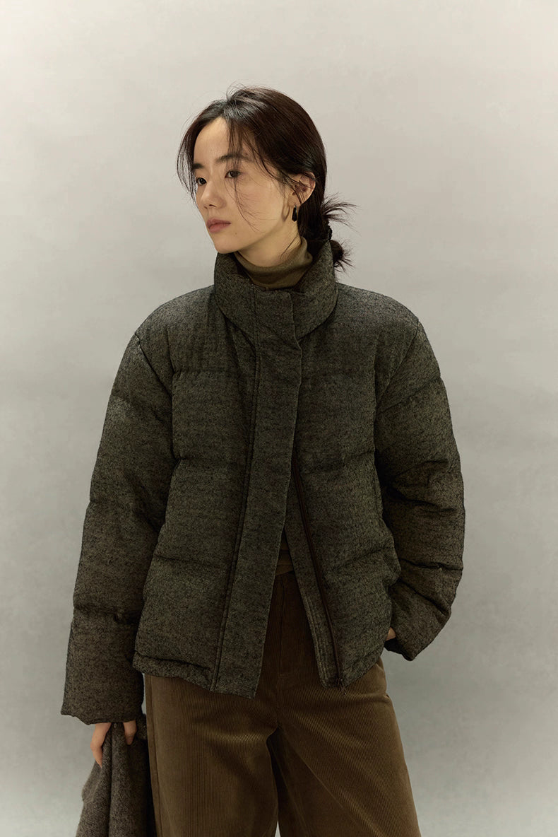 Wool-blend down jacket shown from front as model looks to side.