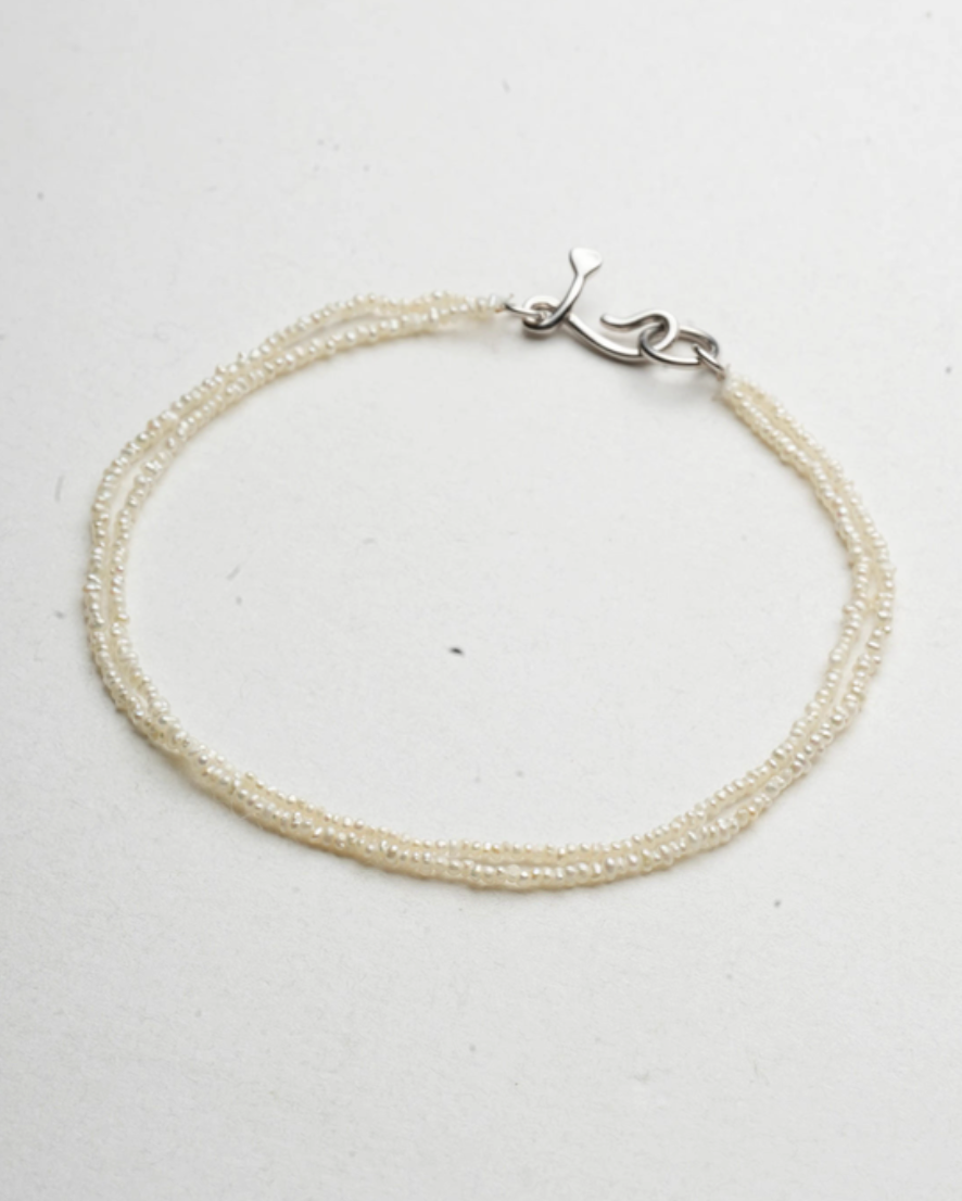 Wrapped Micro Pearl Bracelet with Hand-Formed Silver Clasp natural color angled product view with soft lighting