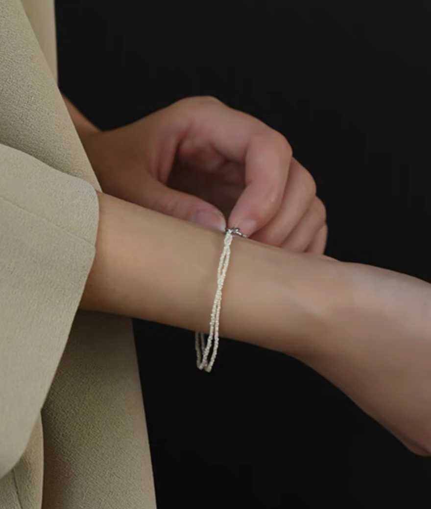 Wrapped Micro Pearl Bracelet with Hand-Formed Silver Clasp natural color close-up of clasp being fastened on wrist