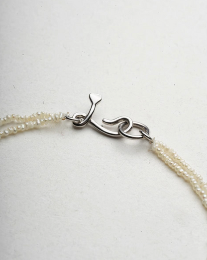 Wrapped Micro Pearl Bracelet with Hand-Formed Silver Clasp natural color close-up of hand-formed silver clasp detail